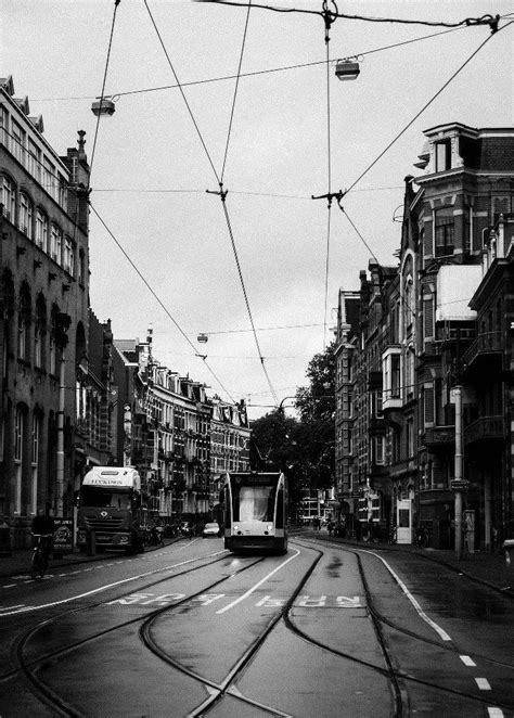 A Trolley Car Is Traveling Down The Street