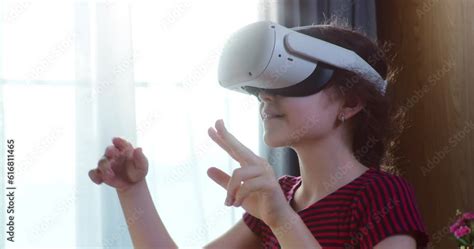 Girl Immersed in cyberspace, learning in virtual reality. Kid playing ...