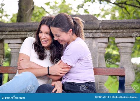 Same Sex Female Couple Sightseeing Around Oxford Uk Sitting On Bench