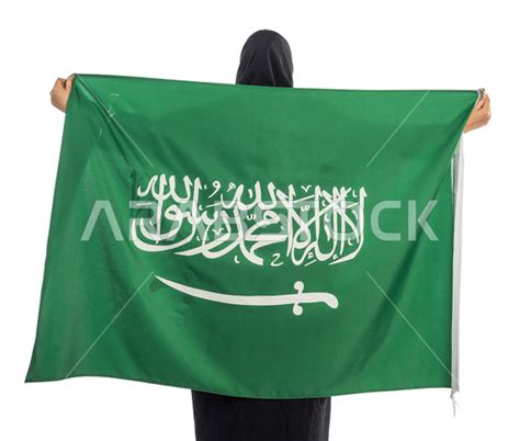 Portrait Of A Saudi Arabian Gulf Woman Holding The Flag Of The Kingdom