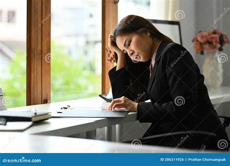 Stressed Female Accountant Touching Her Head Feeling Discouraged