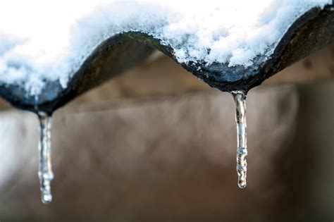 Premium Photo Winter Icicles Hanging From The Roof