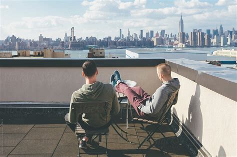 Gay Men Friends Hanging Out On A Rooftop Enjoying The View In New York By Stocksy Contributor