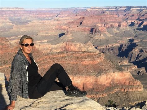 Premium Photo Full Length Portrait Of Woman Sitting On Rock Formation