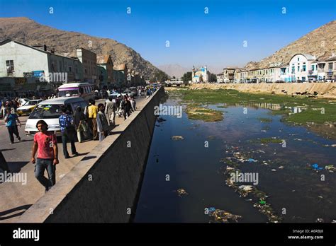 AFGHANISTAN Central Kabul People walk alongside polluted Kabul river ...