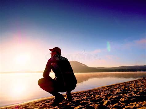 Man Exercising On Beach Silhouette Of Active Man Exercising And