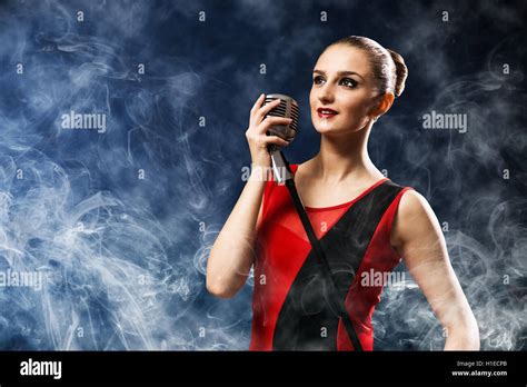 Beautiful Blonde Woman Singer With A Microphone Stock Photo Alamy