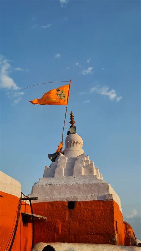 an orange and white building with a flag on top