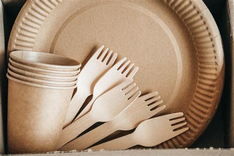 Wooden Forks And Paper Cups With Plates On Kraft Paper Background