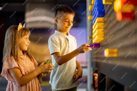 Premium Photo | Kids playing in science museum