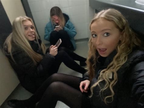 Two Women Sitting On The Floor In Front Of A Mirror Looking At Their