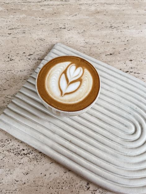 Premium Photo | Cup of coffee latte on the ceramic coaster