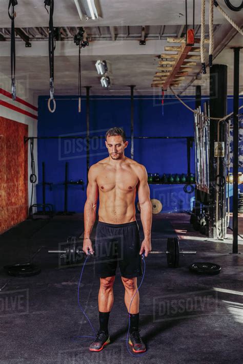 Active Male Athlete With Naked Torso Using Skipping Rope During Training While Working On