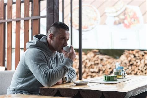 Premium Photo Young Man Drinks Coffee Outdoor