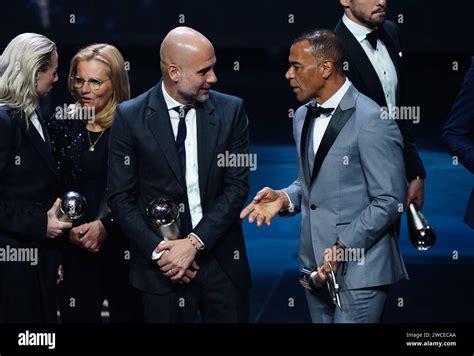 Pep Guardiola (centre) speaks to Cafu on stage with their trophies at ...