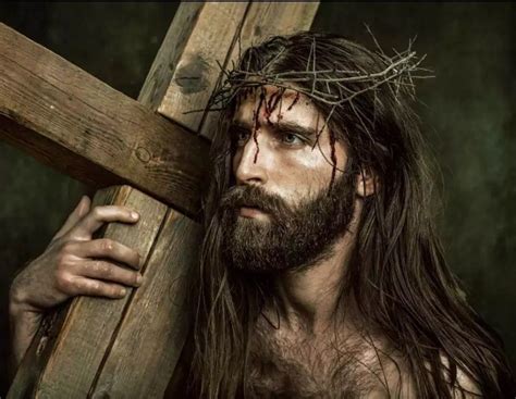 Jesus Carrying The Cross With His Hands And Wearing A Crown Of Thorns