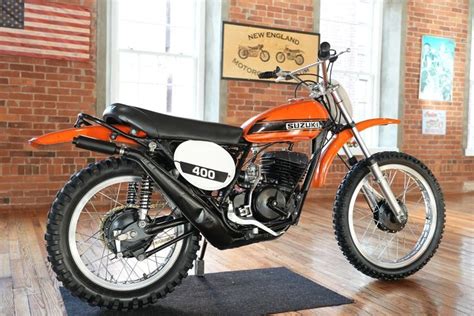 An Orange Dirt Bike Parked On Top Of A Hard Wood Floor