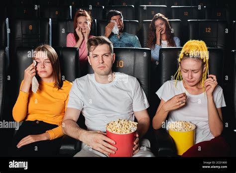 emotional young people watching movie about love,negative feeling and ...