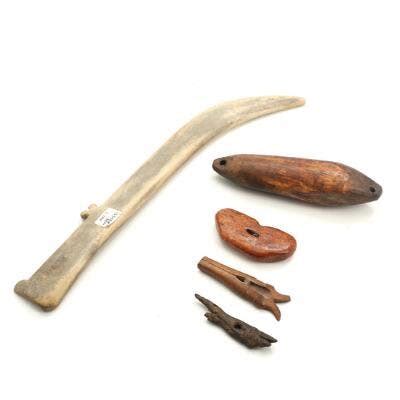 A selection of Inuit hunting tools and utensils of tusk, wood and ...