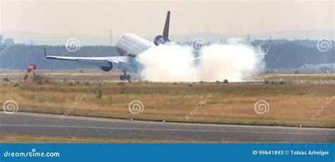 Airplane Landing At An Runway With Tire Smoke Cloud Stock Image Image