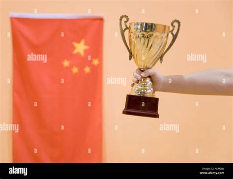 Close Up Of A Person S Hand Holding A Golden Trophy Cup Stock Photo Alamy