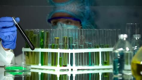 Chemist Checking Tube With Black Substance Petrol Quality Control