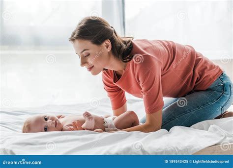 Mother Touching Cute Infant Baby Lying On Bed Stock Image Image Of