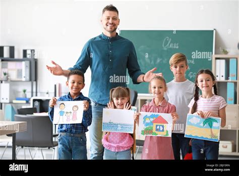 Cute Children With Teacher In Classroom Stock Photo Alamy