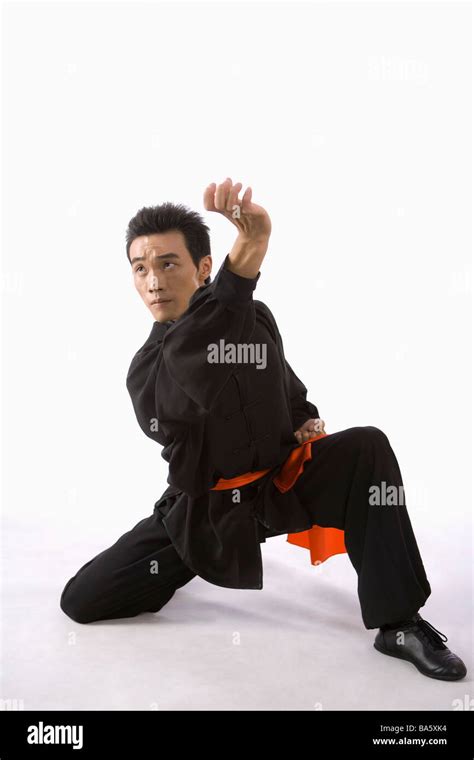 Young man in martial arts pose in studio shot Stock Photo - Alamy