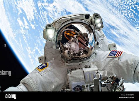 NASA astronaut Mike Hopkins takes a selfie with the Earth as background ...