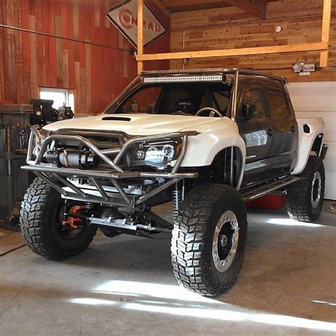 A Large White Truck Parked Inside Of A Garage