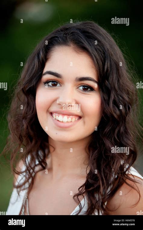 Beautiful Brunette Girl Relaxing In The Park Wiht Many Plants Of Background Stock Photo Alamy