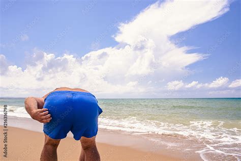 Fat Man Stood In Front Of The Camera Back And Bent Down Spoiling The Seascape With His Ass The