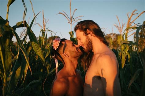 Premium Photo Side View Of Shirtless Gay Couple Romancing While Standing Amidst Plants