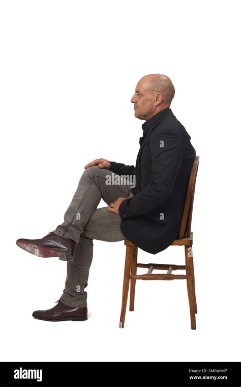 Side View Of A Man Sitting On Chair With Cross Legged On White