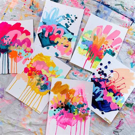 Four Cards With Different Colored Paint Splattered On Them