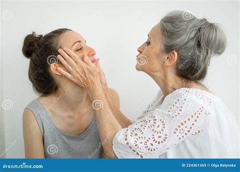 Happy Senior Mother Is Hugging Her Adult Daughter The Women Are