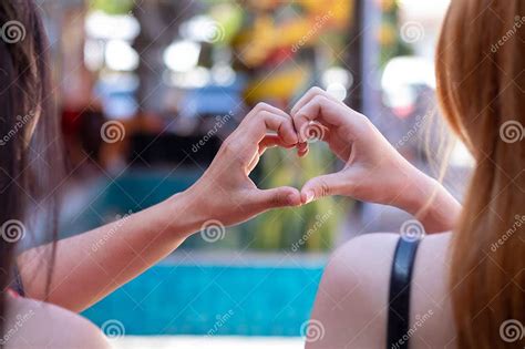 Beautiful Couple Showing Their Hands Up To Form Heart Symbol To Show ...