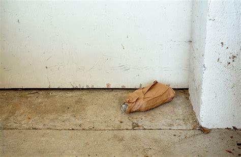 Empty Liquor Bottle In A Brown Paper Bag In A Doorway Del Colaborador