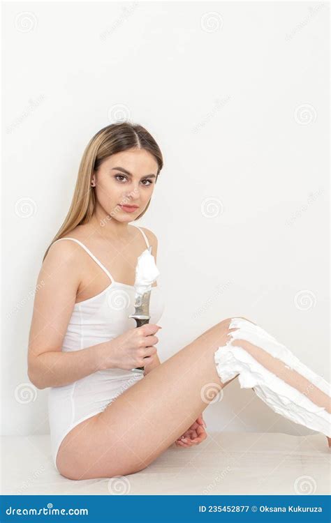 Beautiful Caucasian Woman Shaving Her Legs With A Knife With Shaving