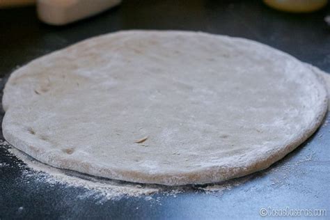 An Uncooked Pizza Dough On A Table