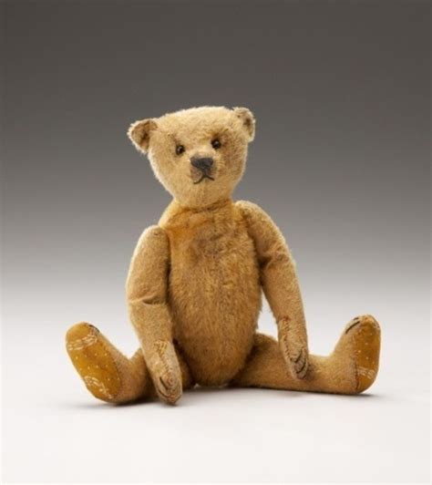 A Brown Teddy Bear Sitting On The Ground