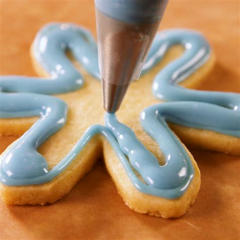 Decorated Cookies On A White Plate Next To A Glass Of Milk And