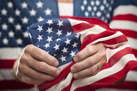 Premium Photo Patriotic Harmony Mans Hand Holding USA Flags