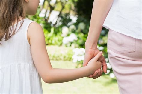 Premium Photo Mother And Daughter Holding Hands