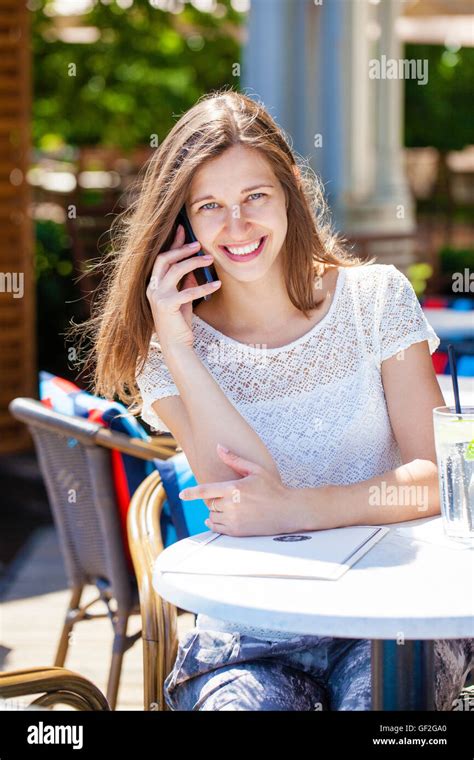 Happy Brunette Woman Calling By Phone In Open Air Cafe Stock Photo Alamy