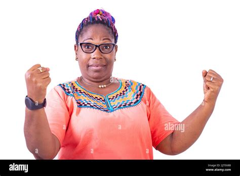 Serious Mature Woman Wearing Glasses Standing While Raising Her Fists And Looking Camera Stock