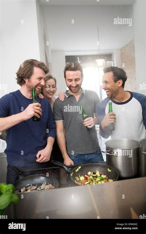 Happy Friends Cooking Together Stock Photo Alamy