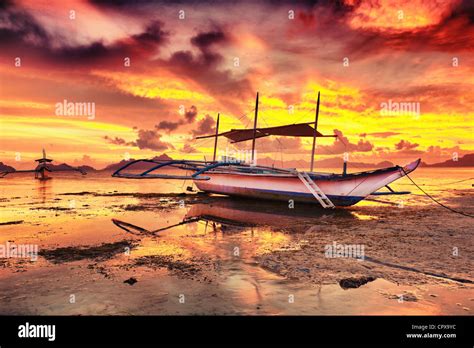 Traditional philippine boat bangka at sunset time Stock Photo - Alamy