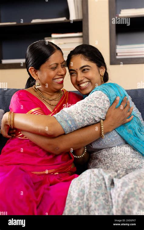 Indian Mother And Teenage Daughter In Traditional Attire Laughing And